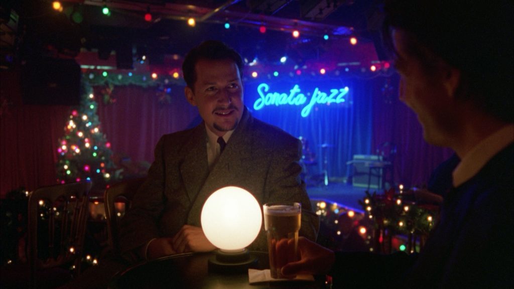 This shot is all about color and focus. The blue backgrounds are use to contrast the white/yellow foreground objects. So the entire scene is exciting to look at, but the focus is strongly on the lit ball and the actor. Meanwhile the soft focus Christmas lights create a dreamlike quality like in the first picture we looked at.